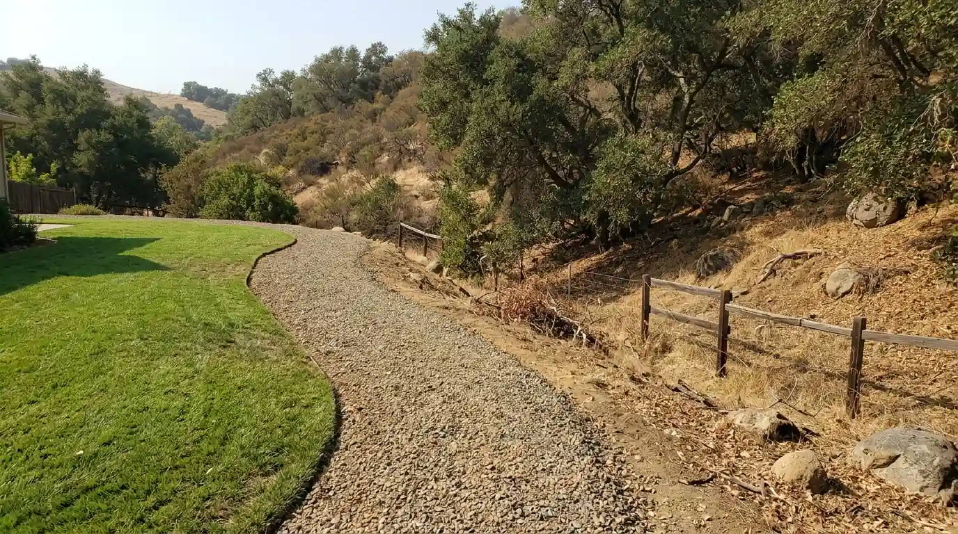 Buffer strip between yard and brush on a San Jose hillside lot